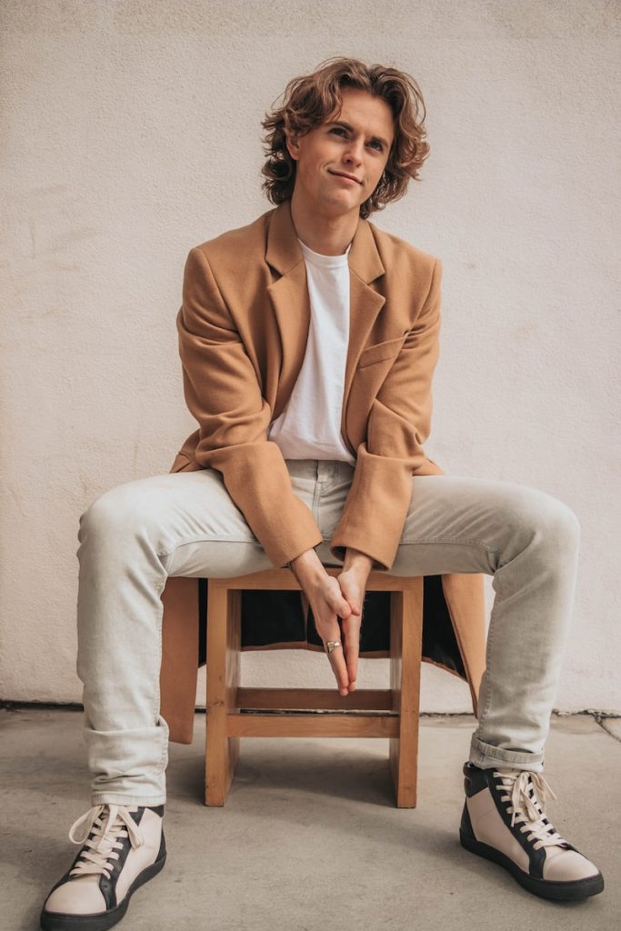 man sitting on a wooden chair