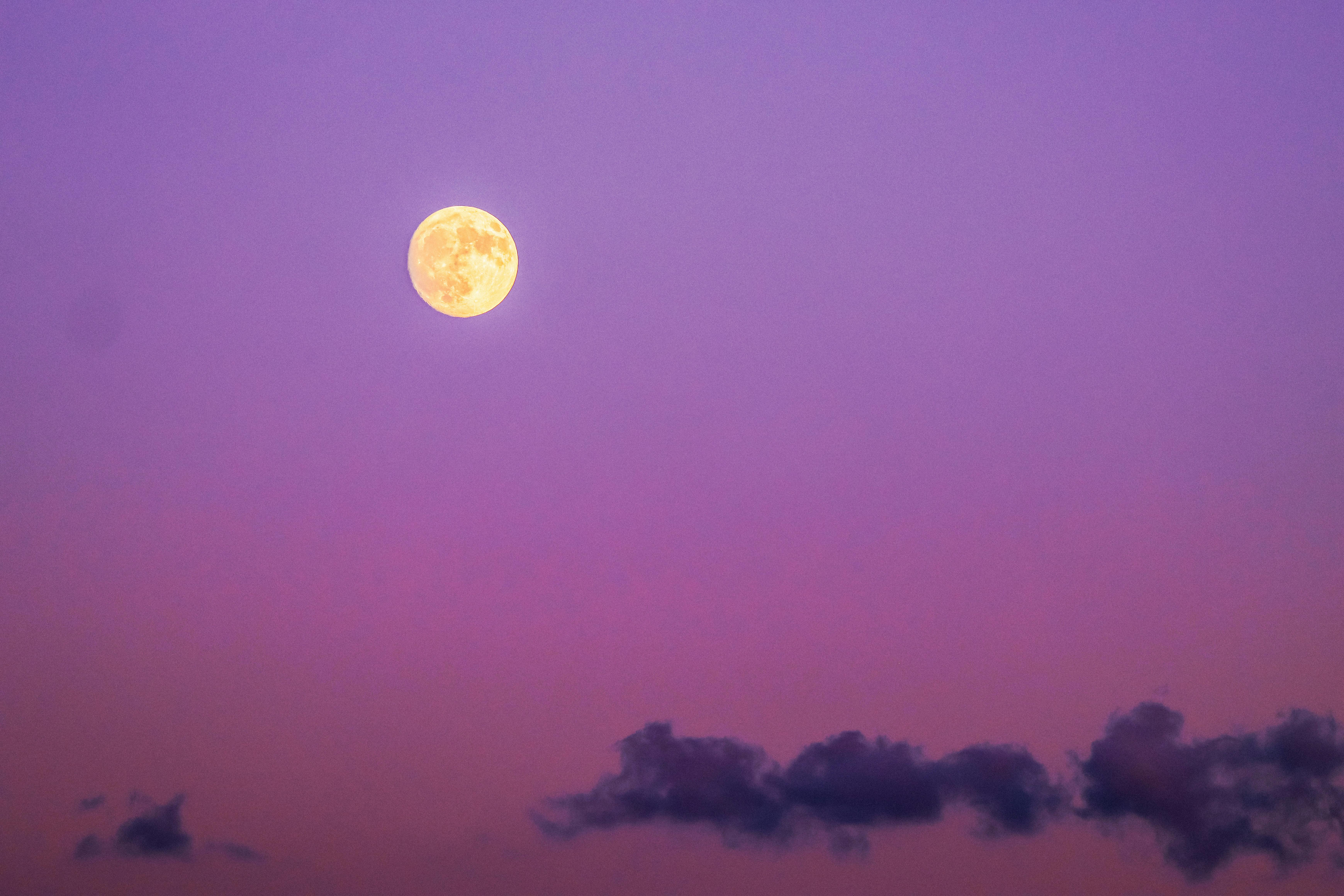 Full moon in a vibrant purple sky over Naxos, Greece, creating a dreamy nightscape.